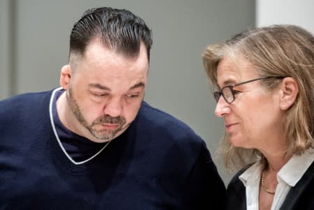 Niels Hoegel, accused of murdering 100 patients at the clinics in Delmenhorst and Oldenburg, speaks to his lawyer Ulrike Baumann during his trial in Oldenburg