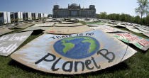 In this Friday, April 24, 2020 file photo, activists place thousands of protest placards in front of the Reichstag building, home of the german federal parliament, Bundestag, during a protest rally of the 'Fridays for Future' movement in Berlin, Germany. World leaders breathed an audible sigh of relief that the United States under President Joe Biden is rejoining the global effort to curb climate change, a cause that his predecessor had shunned. (AP Photo/Michael Sohn, File)