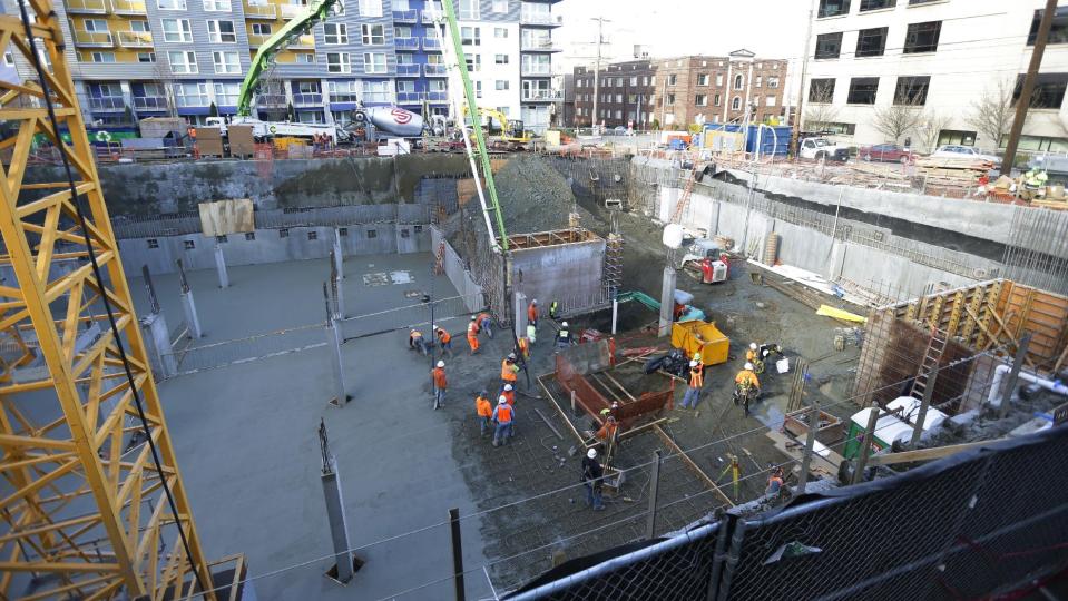 The construction site in Seattle where workers discovered what is believed to be an ice age mammoth tusk is shown Wednesday, Feb. 12, 2014. Work pouring cement at the site was continuing, but workers blocked off the area at the center of the photo where the tusk was found. Paleontologists from the University of Washington hope to move the tusk to a museum on campus. (AP Photo/Ted S. Warren)
