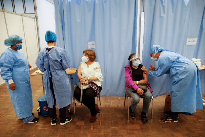 A woman receives her first dose of Russia's Sputnik V vaccine against the coronavirus disease (COVID-19), in Caracas