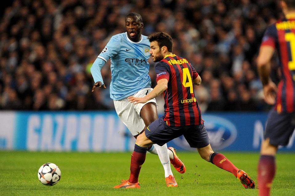 Manchester City's Yaya Toure (left) and Barcelona's Francesc Fabregas battle for the ball