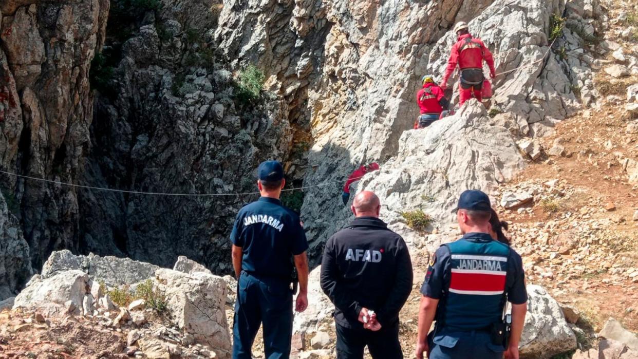 PHOTO: European Cave Rescue Association (ECRA) members and Turkish gendarmerie officers stand next to the entrance of Morca cave near Anamur, southern Turkey, Sept. 7, 2023. (Mithat Unal/Dia Images via AP)