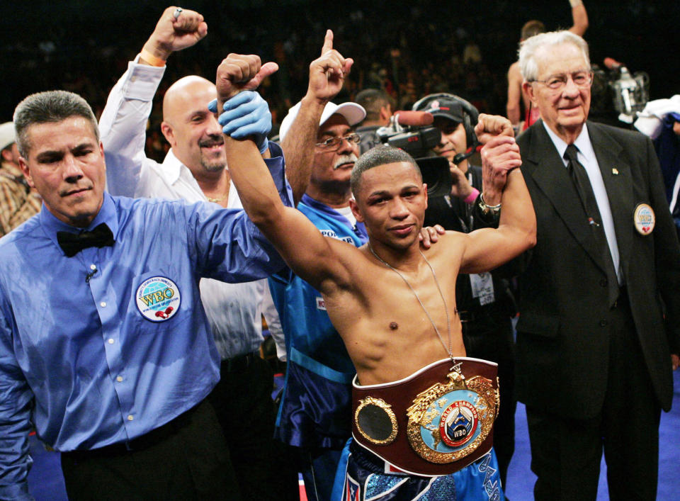 FILE - WBO junior flyweight champion Ivan Calderon, center, from Puerto Rico, celebrates after defeating Mexico's Juan Esquer by unanimous decision in a boxing match in Albuquerque, N.M., Dec. 1, 2007. Calderon was inducted Sunday, June 9, 2024, into the International Boxing Hall of Fame during a ceremony at the Turning Stone Resort Casino in Verona, N.Y. (AP Photo/Jake Schoellkopf, File)