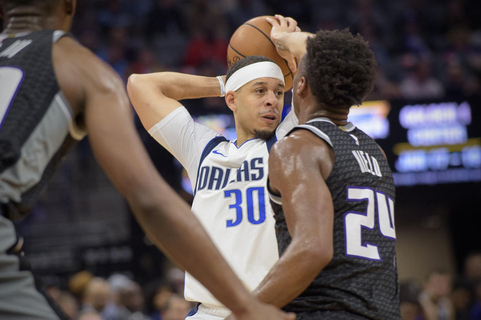 Dallas Mavericks guard Seth Curry (30) passes the ball over Sacramento Kings guard Buddy Hield (24) during the first quarter of an NBA basketball game in Sacramento, Calif., Wednesday, Jan. 15, 2020. (AP Photo/Randall Benton)