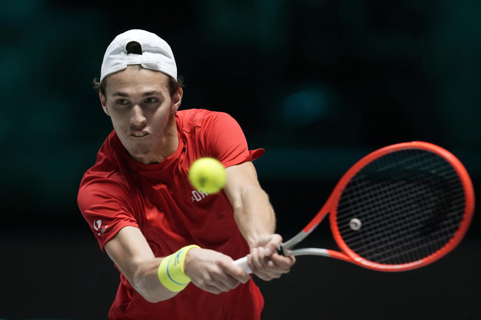 Hungary's Zsombor Piros returns the ball to Croatia's Marin Cilic during their Davis Cup men's single Finals tennis match at the Pala Alpitour in Turin, Italy, Sunday, Nov. 28, 2021. (AP Photo/Antonio Calanni)