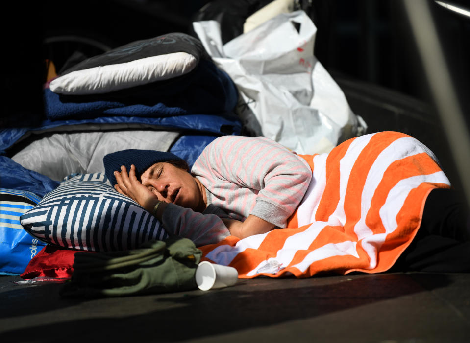 A homeless person sleeping with their belongings in Sydney's Martin Place.