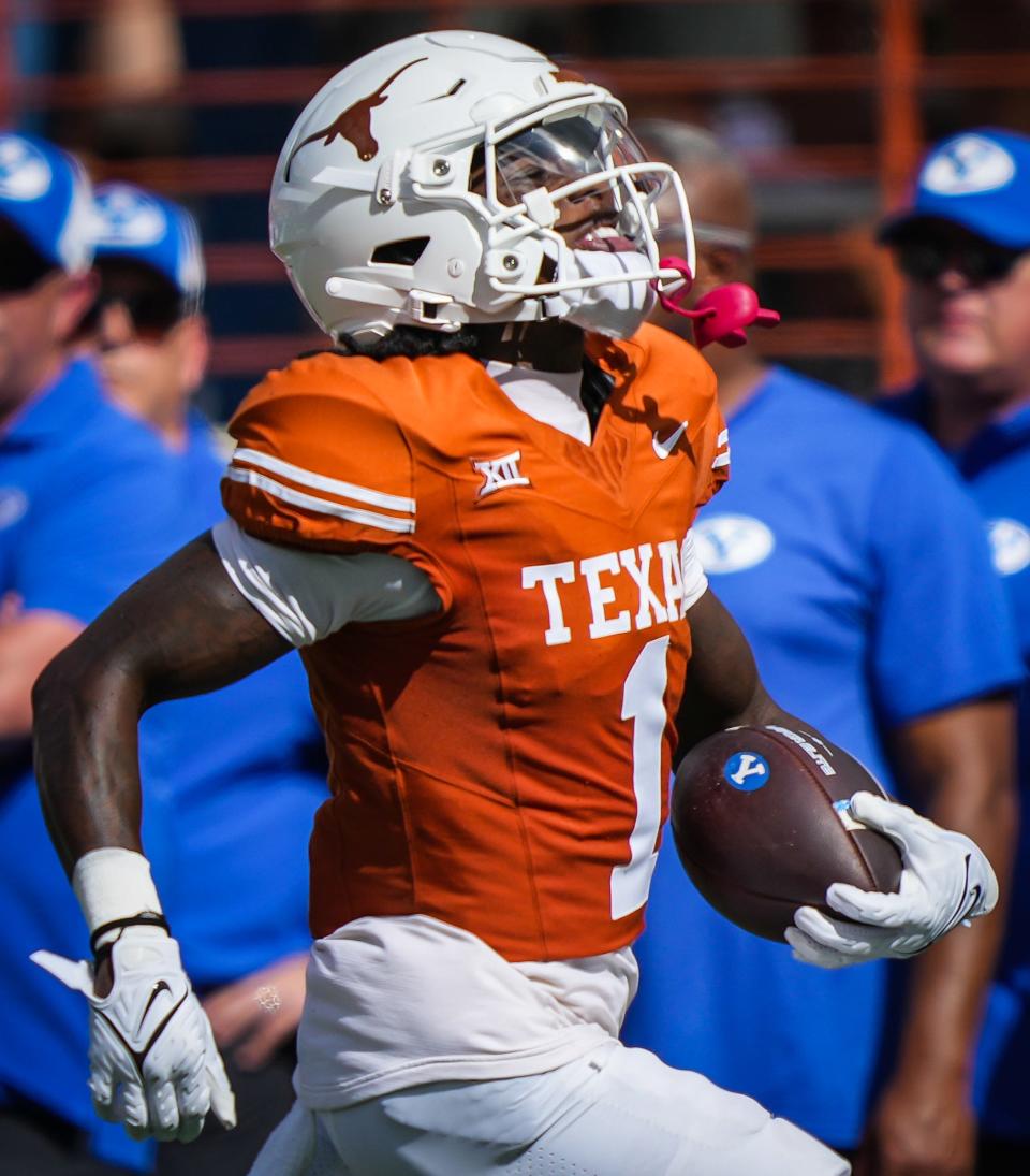 Texas wide receiver Xavier Worthy smiles as he returns an early punt 74 yards for the Longhorns' first touchdown of the game in Saturday's 35-6 win over BYU. Coupled with Oklahoma's loss, Texas finds itself in strong position in the conference race.