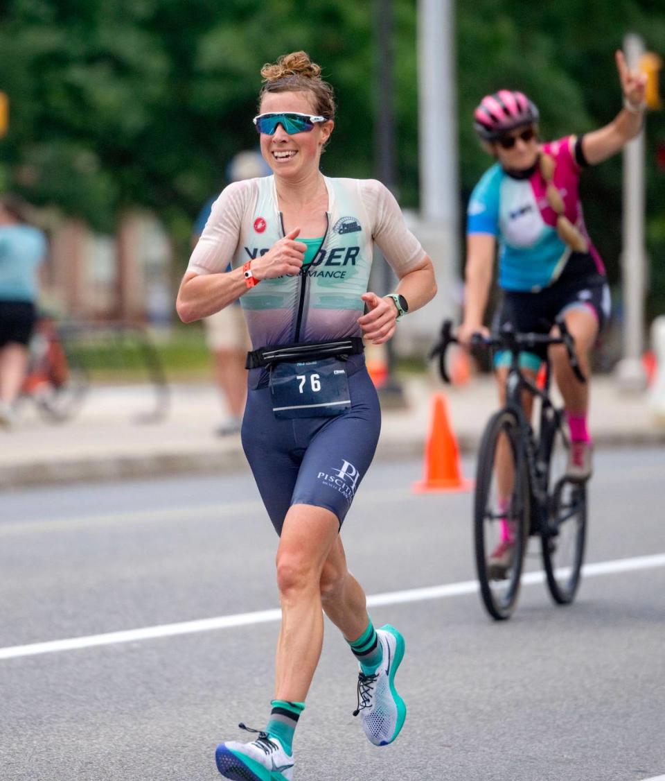 Caroline Moyer runs down Curtin Road towards the finish line of the Ironman 70.3 Pennsylvania Happy Valley on Sunday, June 30, 2024. Moyer was the first female finisher with a time of 5:02:11.