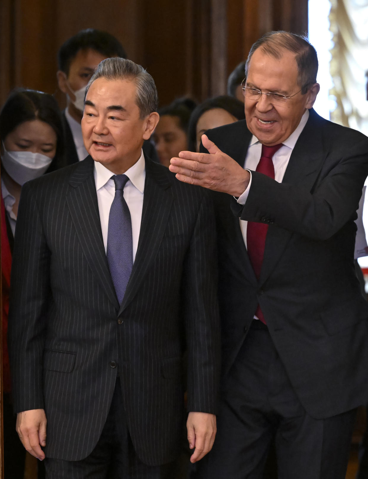 Russian Foreign Minister Sergey Lavrov, right, welcomes the Chinese Communist Party's foreign policy chief Wang Yi for their talks in Moscow, Russia, Wednesday, Feb. 22, 2023. (Alexander Nemenov/Pool Photo via AP)