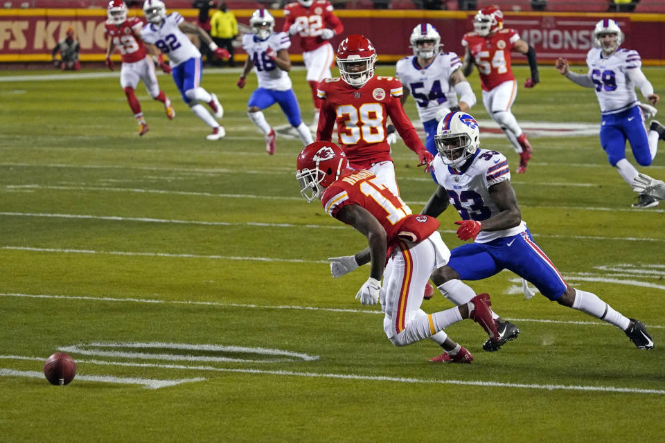 Kansas City Chiefs wide receiver Mecole Hardman (17) fumbles a punt in front of Buffalo Bills cornerback Siran Neal (33) during the first half of the AFC championship NFL football game, Sunday, Jan. 24, 2021, in Kansas City, Mo. Buffalo recovered the fumble. (AP Photo/Jeff Roberson)