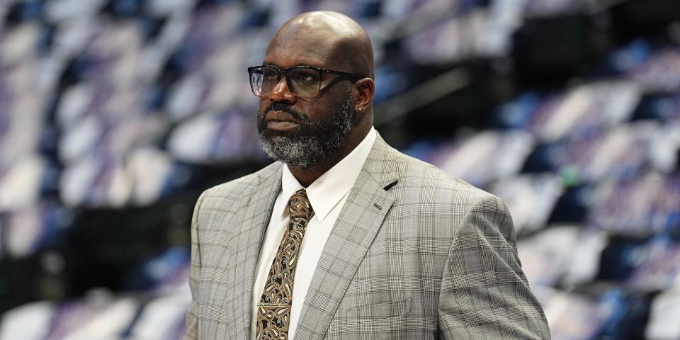 Shaquille O'Neal looks on from the sidelines in an empty NBA arena in 2022.