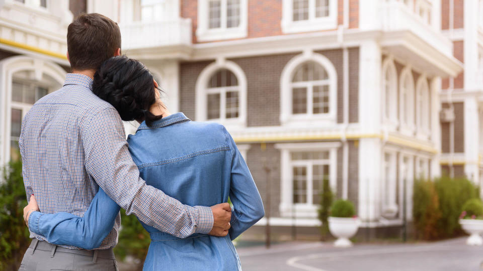 Man and woman hugging outdoors.