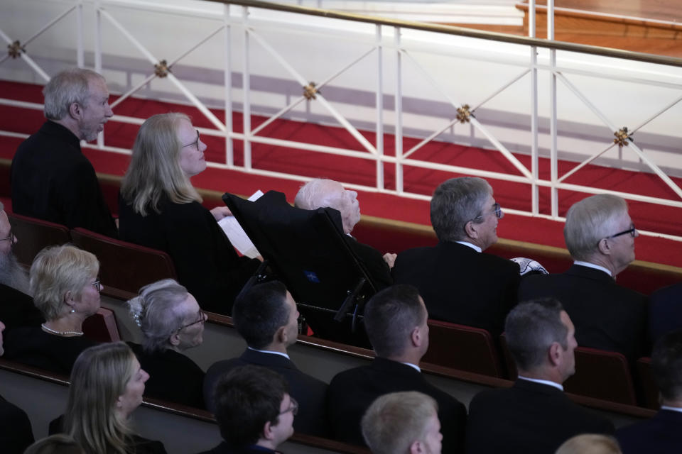 Former President Jimmy Carter, center, surrounded by his children, from left, Jeff, Amy, James and Jack, attend a tribute service for former first lady Rosalynn Carter, at the Glenn Memorial Church, in Atlanta, Tuesday, Nov. 28, 2023. The pews filled with political power players, but front and center were her children and dozens of grandchildren and great-grandchildren — all surrounding Jimmy Carter, her partner of 77 years. (AP Photo/Andrew Harnik)
