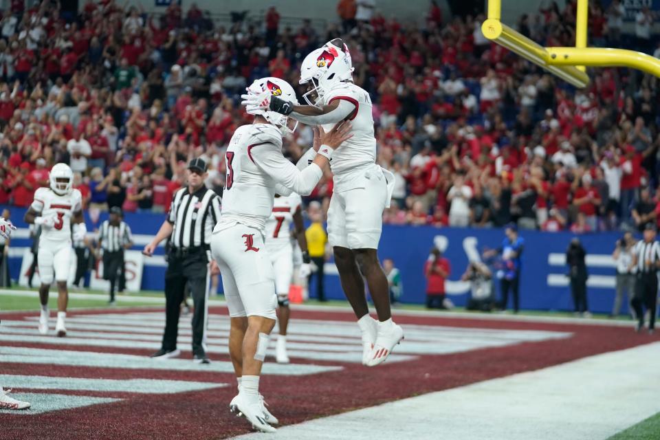 Louisville running back Maurice Turner, right, celebrates a touchdown run with quarterback Jack Plummer during the first half of an NCAA college football game against Indiana, Saturday, Sept. 16, 2023, in Indianapolis.