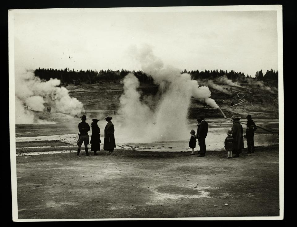 People watch The Geyser Basins at Yellowstone National Park in January 1920.