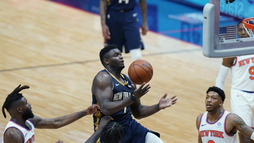 New Orleans Pelicans forward Zion Williamson (1) is fouled as he drives to the basket between New York Knicks forward Reggie Bullock, left, and guard Elfrid Payton in the second half of an NBA basketball game in New Orleans, Wednesday, April 14, 2021. (AP Photo/Gerald Herbert)