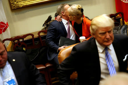 FILE PHOTO - White House Senior Advisor Kellyanne Conway (2nd R) embraces Communications Director Sean Spicer as he joins a roundtable discussion between U.S. President Donald Trump and labor leaders, after Spicer's first press briefing at the White House in Washington, U.S. January 23, 2017. REUTERS/Jonathan Ernst/File Photo