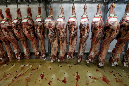 Meat hangs from hooks in the meat pavillion at the Rungis International wholesale food market as buyers prepare for the Christmas holiday season in Rungis, south of Paris, France, November 30, 2017. Picture taken November 30, 2017. REUTERS/Benoit Tessier