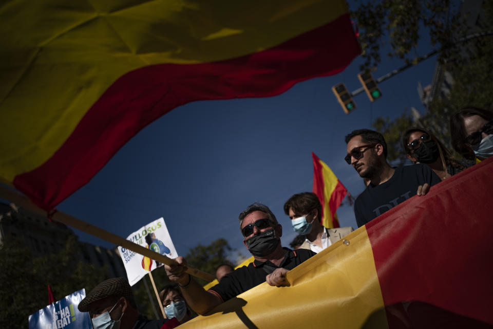 Demonstrators march during a celebration for Spain's National Day in Barcelona, Spain, Tuesday, Oct. 12, 2021. Spain commemorates Christopher Columbus' arrival in the New World and also Spain's armed forces day. (AP Photo/Joan Mateu Parra)