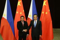 Philippines President Rodrigo Duterte (L) shakes hands with Chinese Premier Li Keqiang ahead of their meeting at the Great Hall of the People in Beijing, on October 20, 2016