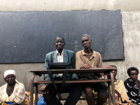 People rescued after after Cyclone Idai sit in a school class room in Guara Guara outside Beira, Mozambique, March 22, 2019. REUTERS/Emma Rumney