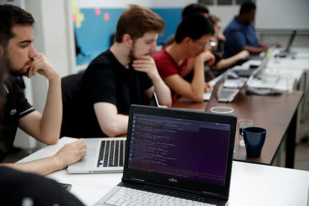 Students work in their web development class as part of professional training at the Simplon school specialized in digital sector in Montreuil, near Paris, France, June 14, 2018. Picture taken June 14, 2018. REUTERS/Philippe Wojazer