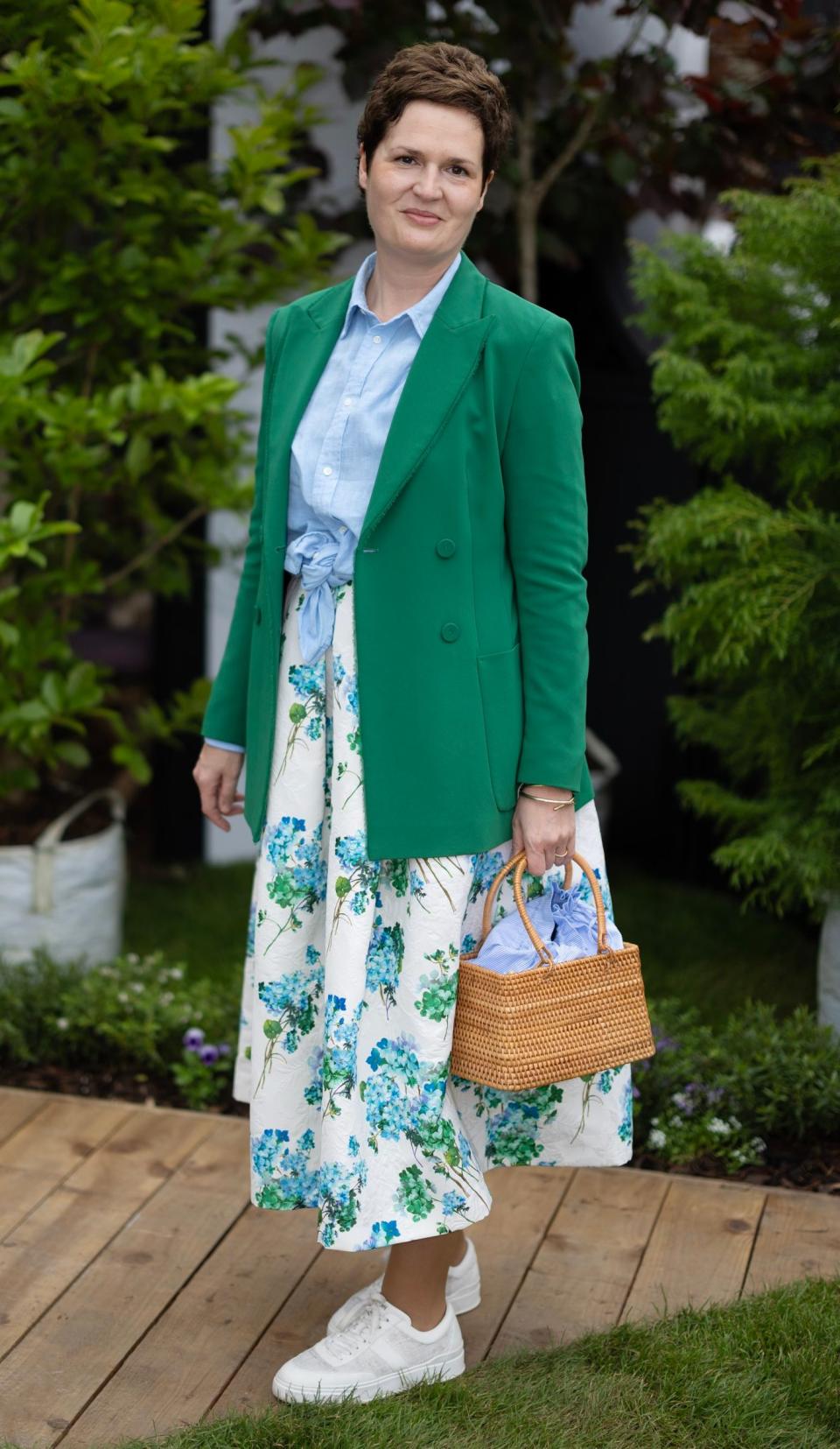 Franziska Odemar, 42, wears a hydrangea print skirt with a linen Ralph Lauren shirt and a green Marc Cain jacket. She carries a Max Mara basket bag