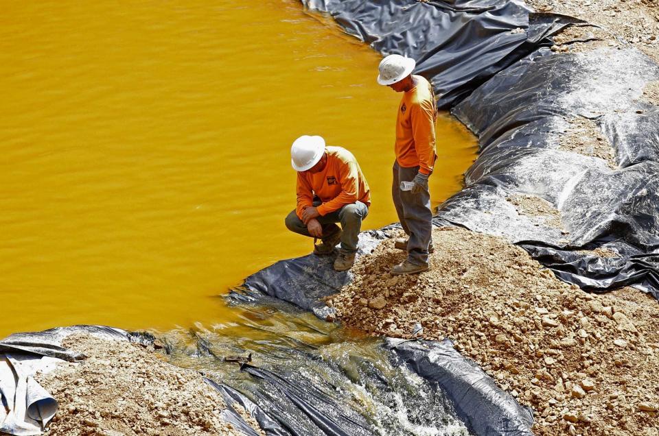 Environmental Restoration LLC employees worked on a temporary water treatment holding facility at the Gold King Mine north of Silverton, Colorado, in 2015.