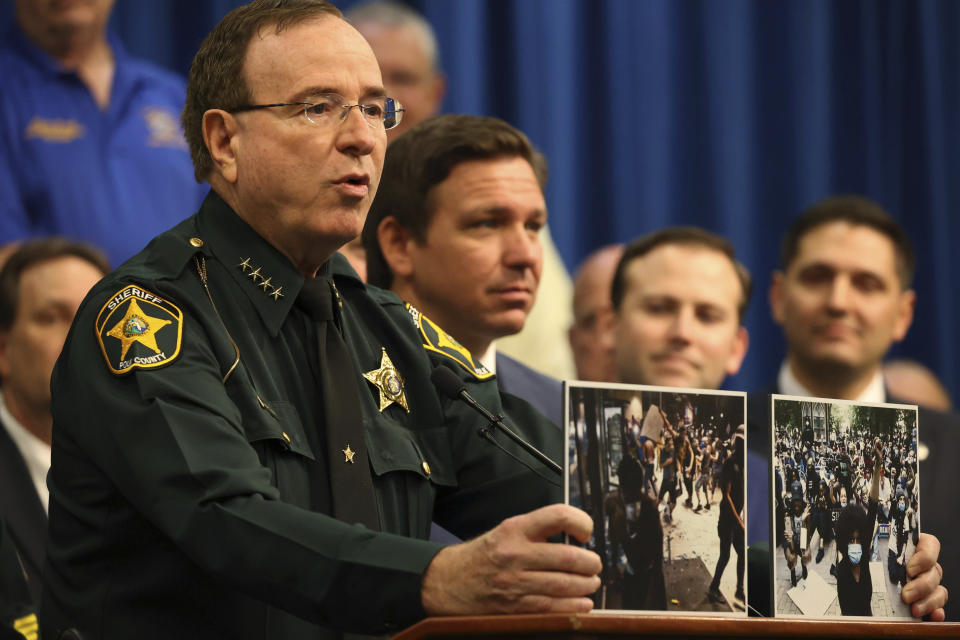Polk County Sheriff Grady Judd speaks during a press conference with Gov. Ron DeSantis at the Polk County Sheriff's Office in Winter Haven, Fla., on, April 19, 2021. Sheriff Judd, with his folksy Southern drawl, uses social media to target drug dealers, prostitution rings, gangs and human traffickers. (Ricardo Ramirez Buxeda/Orlando Sentinel via AP)