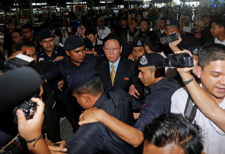 North Korean Ambassador to Malaysia Kang Chol (C), who was expelled from Malaysia, is surrounded as he arrives at Kuala Lumpur international airport in Sepang, Malaysia March 6, 2017. REUTERS/Lai Seng Sin