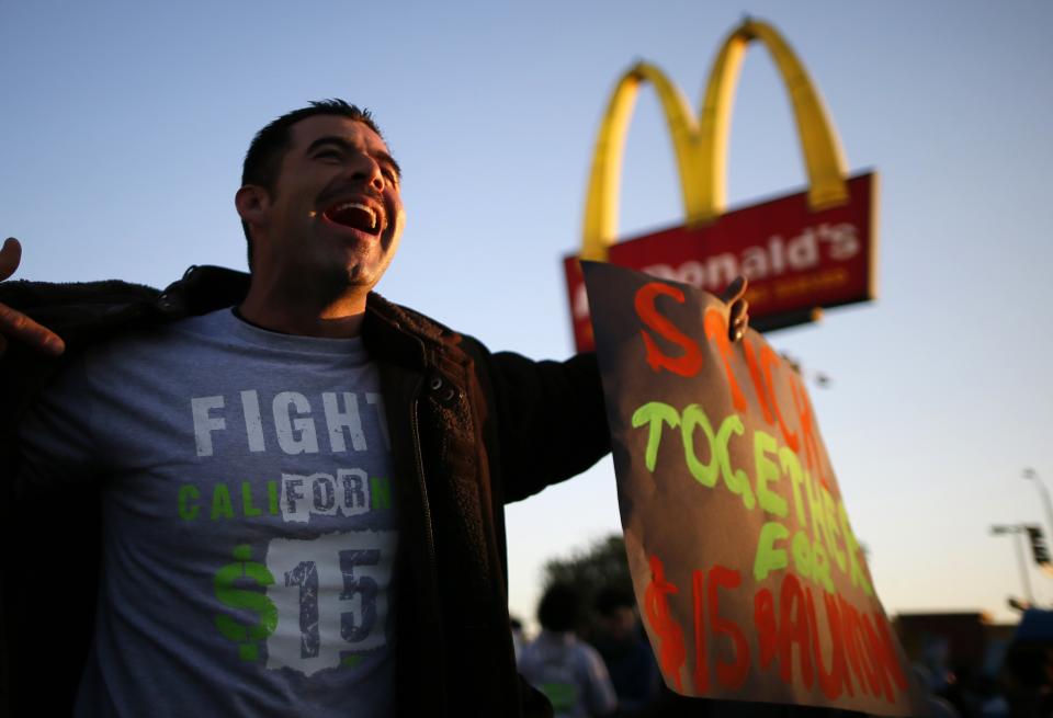 Striking McDonald's worker Abran Escarzaga, 31, protests outside McDonald's in Los Angeles, California, December 5, 2013. Organizers say fast food workers will strike in 100 U.S. cities, and there will be protests in 100 more, to fight for $15 an hour wages and the right to form a union. (REUTERS/Lucy Nicholson)