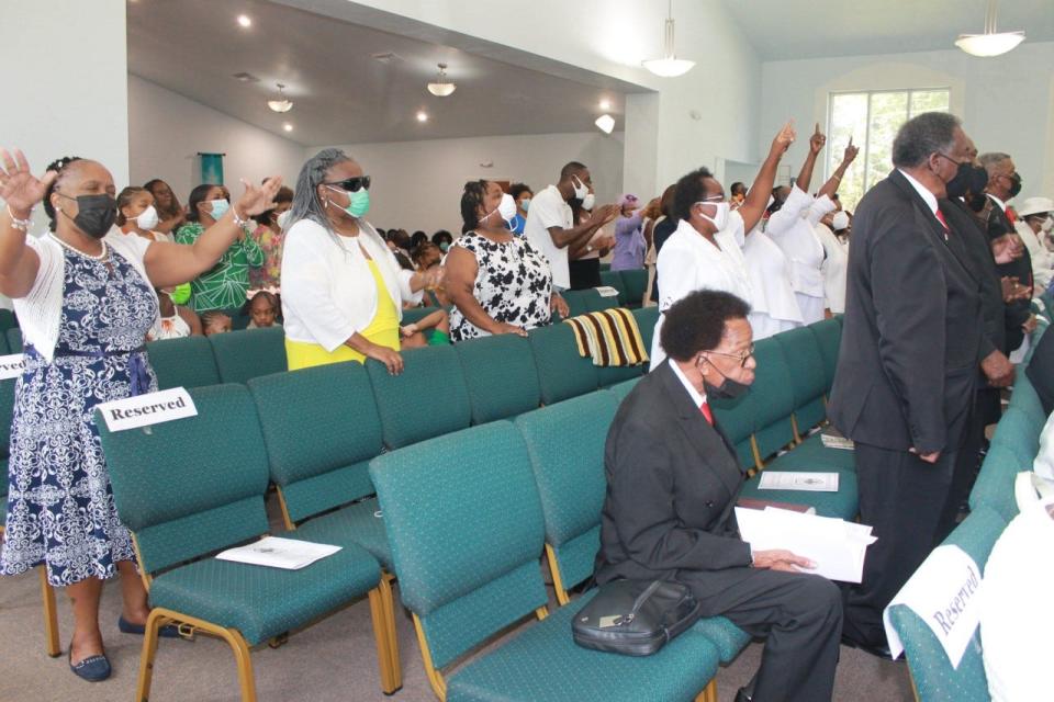 Parishioners praise the Lord during a convocation service held Sunday at DaySpring Baptist Church to recognize 12 members of the church who were elevated and consecrated during the service.