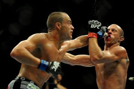 Sep 27, 2014; Las Vegas, NV, USA; Donald Cerrone (red gloves) fights Eddie Alvarez (blue gloves) during a lightweight fight at UFC 178 at MGM Grand Garden Arena. Mandatory Credit: Stephen R. Sylvanie-USA TODAY Sports