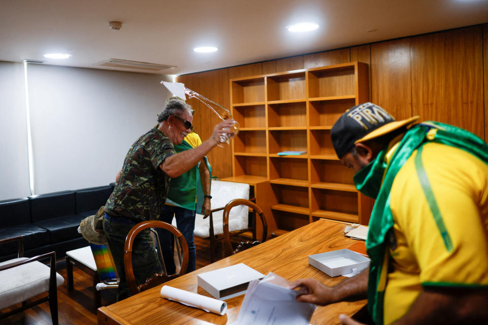 Supporters of Brazil&#39;s former President Jair Bolsonaro vandalize an office in Planalto Palace.