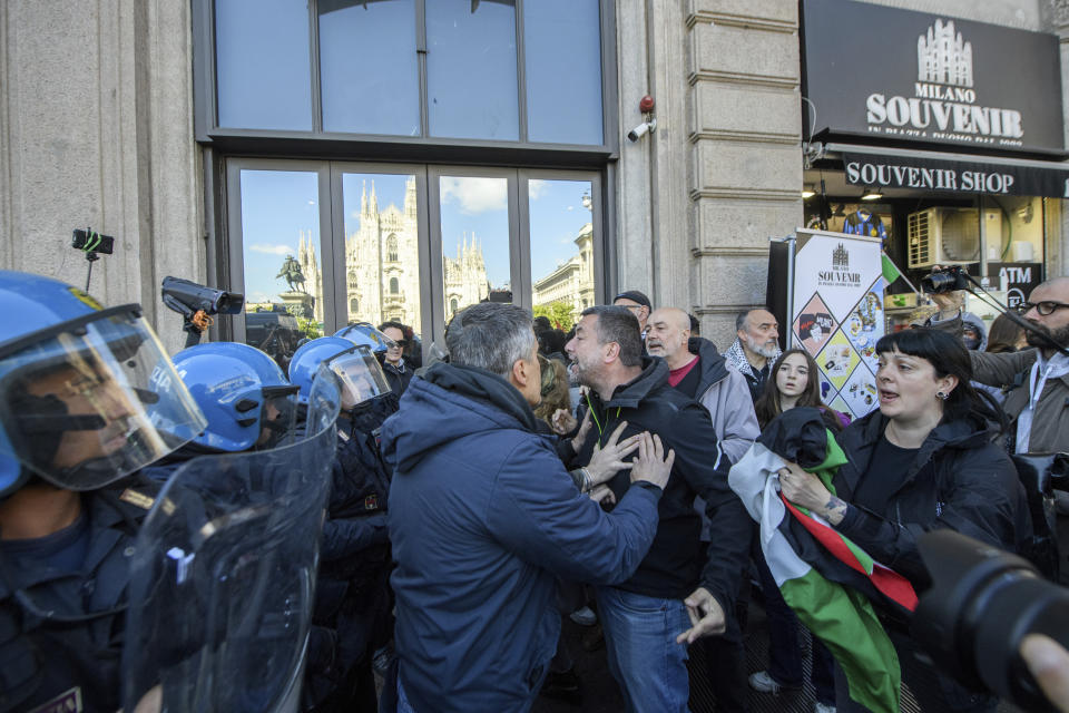 Police face people holding Palestinians flags as they march on the occasion of Liberation Day in Milan, Italy, Thursday, April 25, 2024. Italy is marking its liberation from Nazi occupation and fascist rule amid a fresh media controversy over the legacy of Italian fascist complicity in the Holocaust and World War II-era crimes. Premier Giorgia Meloni, whose Brothers of Italy party traces its roots to the neo-fascist movement that emerged after the fall of dictator Benito Mussolini, joined the Italian president at the tomb of the unknown soldier in Rome. (Claudio Furlan/LaPresse via AP)