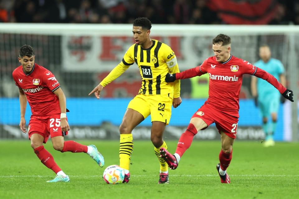  Jude Bellingham of Borussia Dortmund is challenged by Florian Wirtz of Bayer 04 Leverkusen (Getty Images)