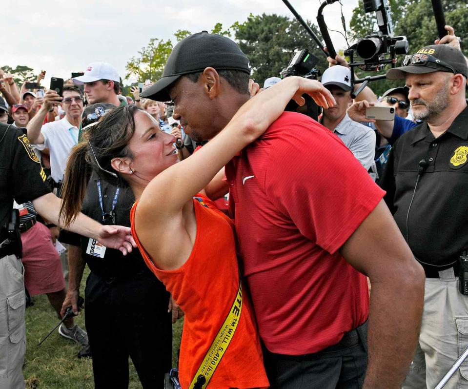 Tiger Woods and his girlfriend Erica Herman celebrate after the final round of the TOUR Championship at East Lake Golf Club on September 23, 2018, in Atlanta, Georgia
