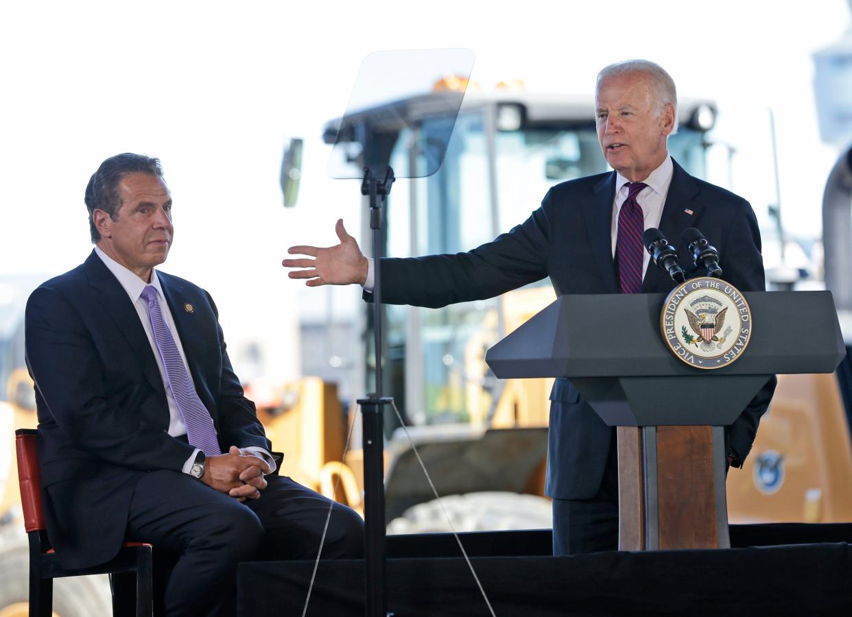 While New York Gov. Andrew Cuomo, left, looks on, then-Vice President Joe Biden speaks during a news conference at LaGuardia Airport in New York, Tuesday, June 14, 2016. Cuomo and Biden were helping to announce and break ground on major infrastructure improvements at the airport.