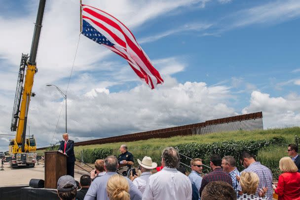 PHOTO: FILE - People listen to former President Donald Trump's address during a tour to an unfinished section of the border wall, June 30, 2021 in Pharr, Texas. (Brandon Bell/Getty Images, FILE)