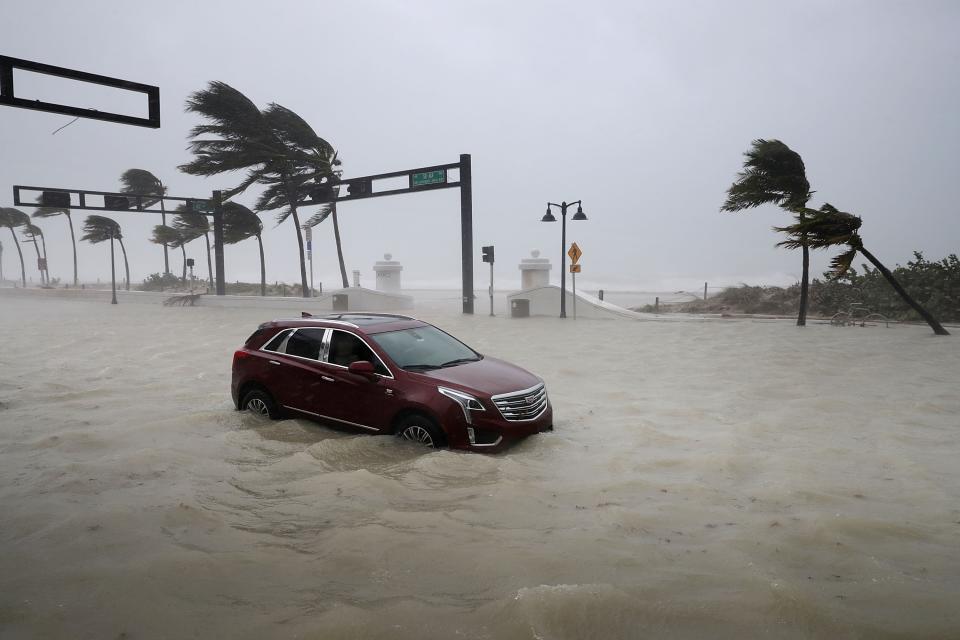 A car sits abandoned in storm surge along North Fort Lauderdale Beach Boulevard as Hurricane Irma hits the southern part of the state September 10, 2017 in Fort Lauderdale, Florida. (Photo by Chip Somodevilla/Getty Images)