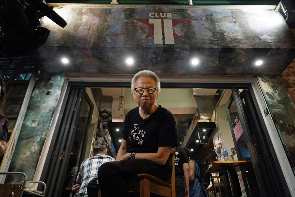 In this Oct. 9, 2020 photo, owner Grace Ma poses for a photo at her bar Club 71 in Central, a business district of Hong Kong. Nearly 15 years ago, the bar known as a gathering place for pro-democracy activists and intellectuals is closing. Ma blames government-mandated bar closures and coronavirus restrictions for its financial strain. (AP Photo/Kin Cheung)