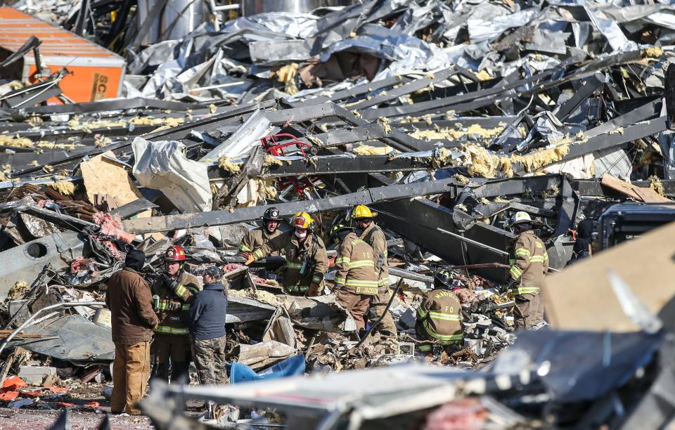 Rescue teams search for people among the remains of a candle factory Dec. 11 in Mayfield, Ky., after a deadly tornado ripped through the small community.