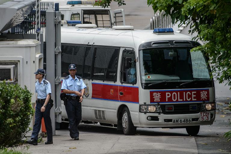 Hong Kong police are pictured at the entrance of a local police college in Hong Kong on June 25, 2014