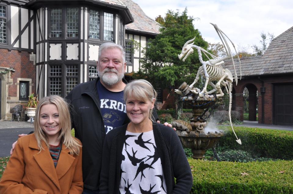 The McFadden family, from left, daughter Alexandria, husband David and wife Christine, decorate the iconic Tudor Rose estate in Canton for Halloween and Christmas. Inside and outside, it's spirited.