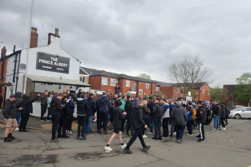Fans gathered outside one of Edgeley's pubs as they prepare to party into the night -Credit:Manchester Evening News
