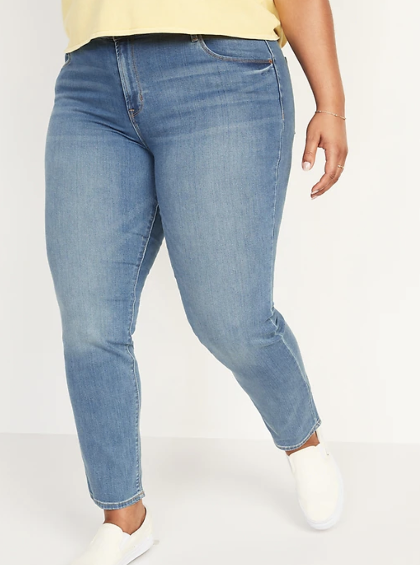 plus size model wearing blue Mid-Rise Power Slim Straight Jeans 