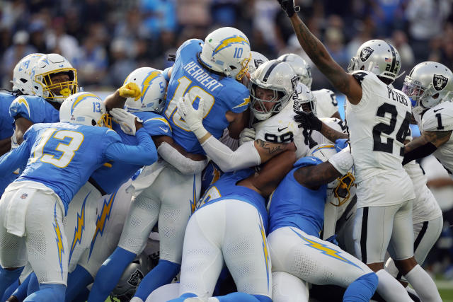 Los Angeles Chargers quarterback Justin Herbert (10) adjusts his