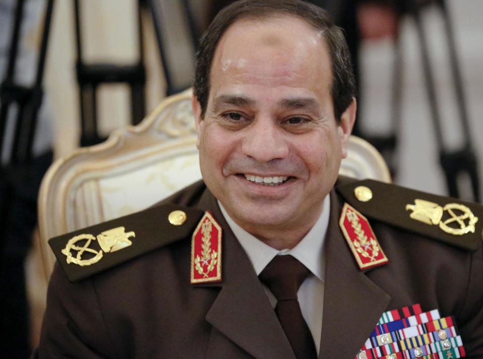 FILE - In this Thursday, Feb. 13, 2014 file photo, Egypt’s military chief Field Marshal Abdel-Fattah el-Sissi smiles as he speaks to Foreign Minister Sergey Lavrov during their talks along with Egyptian Foreign Minister Nabil Fahmy and Russian Defense Minister Sergei Shoigu in Moscow, Russia. Former military chief Abdel-Fattah el-Sissi, if he wins Egypt’s presidency as is widely expected, will have an overwhelming presence over a shattered political scene. Egypt’s once dominant political force, the Muslim Brotherhood, is exhausted under a relentless crackdown. Non-Islamist parties are weak and largely acquiescent to his power. But the political vacuum is hardly a stable one. The Brotherhood is betting that with time the public will turn against el-Sissi. (AP Photo/Alexander Zemlianichenko, File)