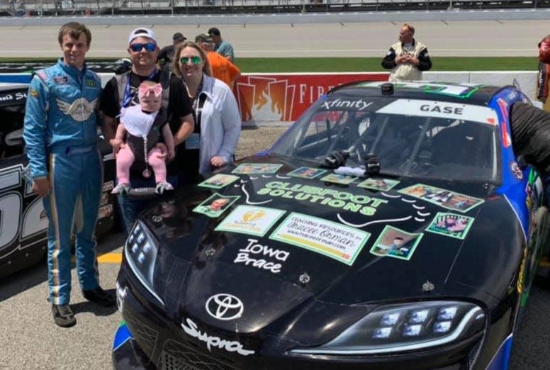 Joey Gase promoted clubfoot awareness at Michigan International Speedway prior to Covid, posing for this photo with Jessica and Taylor Matheny and their daughter Merritt, who was undergoing clubfoot treatment.