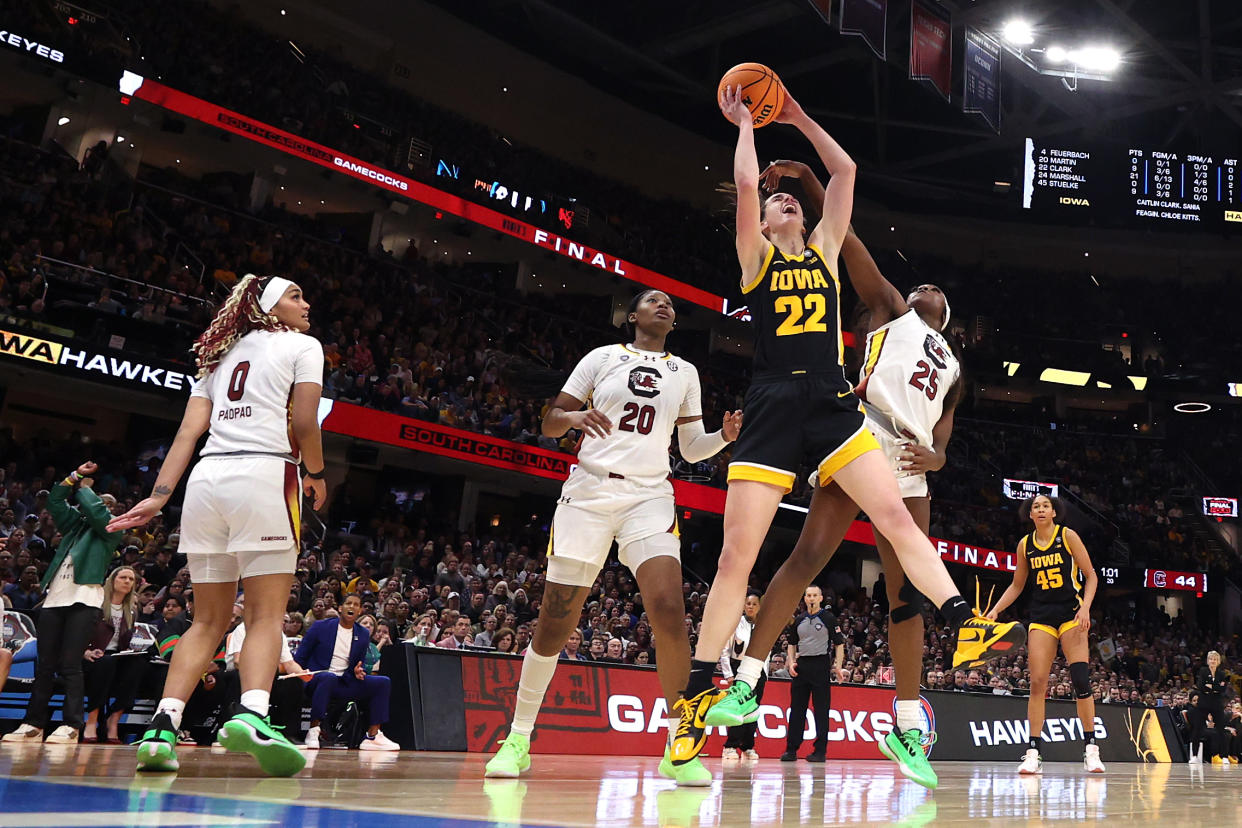 CLEVELAND, OHIO - APRIL 07: Caitlin Clark #22 of the Iowa Hawkeyes works to shoot around Sania Feagin #20 and Raven Johnson #25 of the South Carolina Gamecocks in the 2024 NCAA Women's Basketball Tournament National Championship at Rocket Mortgage FieldHouse on April 07, 2024 in Cleveland, Ohio. South Carolina beat Iowa 87-75. (Photo by Steph Chambers/Getty Images)